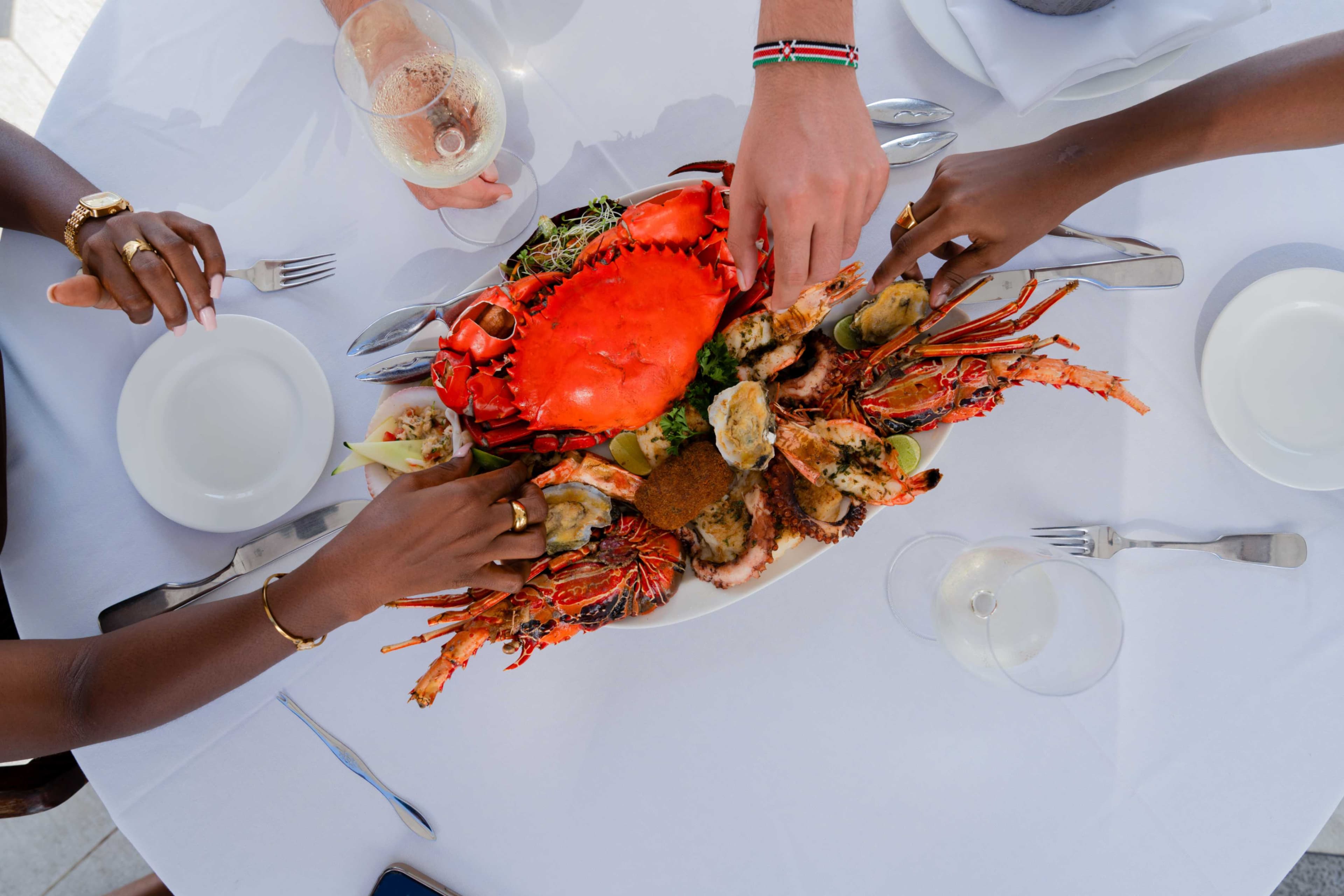 A seafood platter featuring a bright red crab and lobster at Tamarind Mombasa